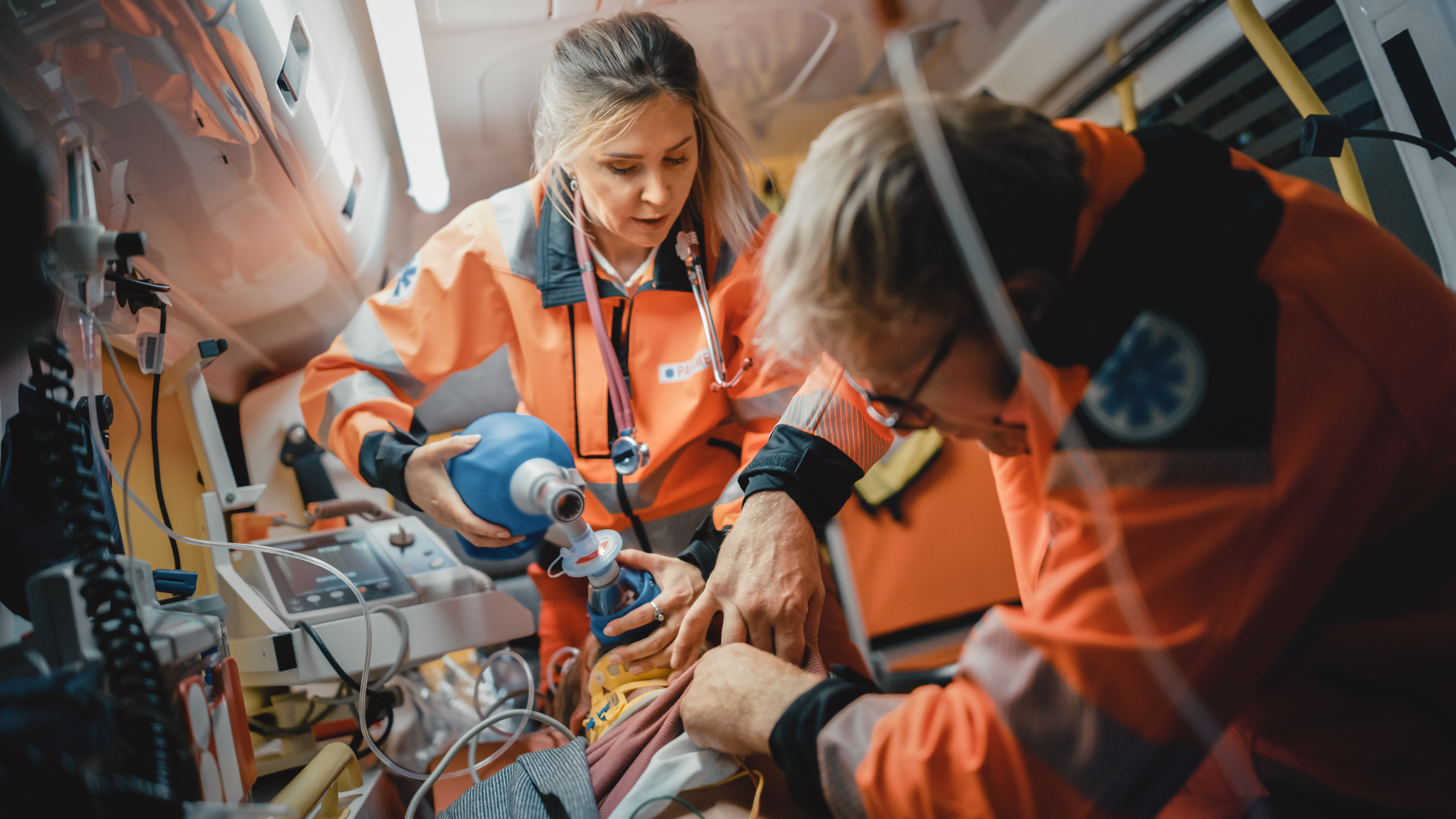 Paramedic giving care in ambulance